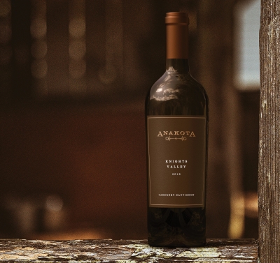 Single bottle of cabernet Sauvignon on a piece of barn wood