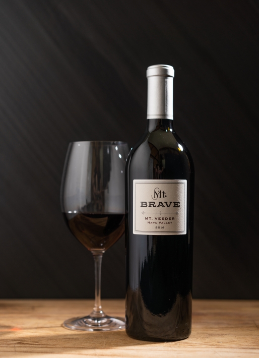 Bottle of red wine against a dark background