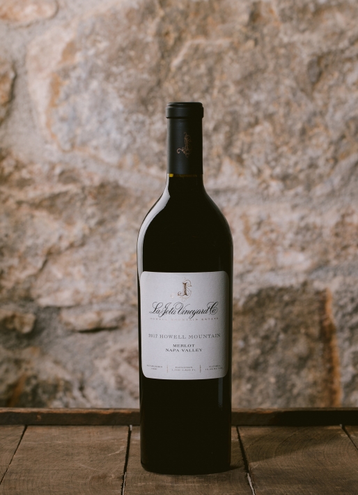 Single bottle of red wine against a stone background 